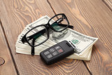 Money cash, glasses and car remote key
