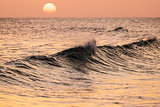 Breaking wave at sunset