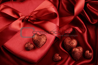 A group of red hearts on satin background