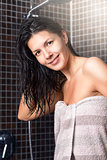 Woman with wet hair standing in a shower