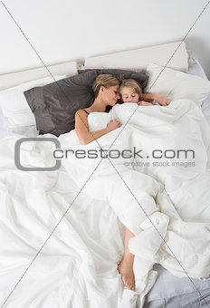 Mother and daughter sleeping from high angle view