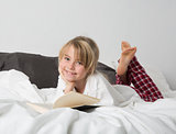 Smiling Young Girl Reading a book