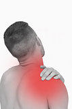 Rear view of shirtless man with shoulder pain