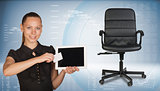 Businesswoman holding tablet PC and business card. Office chair beside
