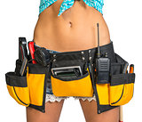 Woman wearing tool belt with tools, close up