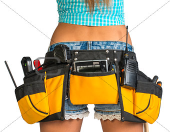 Woman wearing tool belt with tools, close up