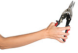 Female hand holding tin snips