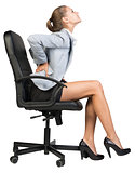 Businesswoman with lower back pain from sitting on office chair