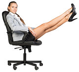 Businesswoman on office chair with her feet up