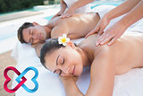 Composite image of attractive couple enjoying couples massage poolside