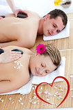 Composite image of young couple enjoying a back massage with stone
