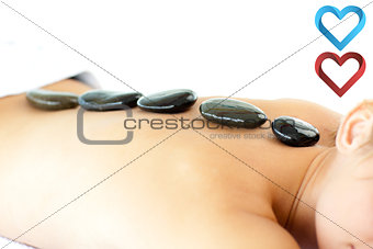 Composite image of portrait of a positive woman having a massage