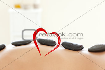 Composite image of woman lying on a massage table