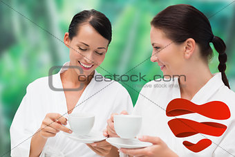 Composite image of beautiful friends in bathrobes drinking herbal tea