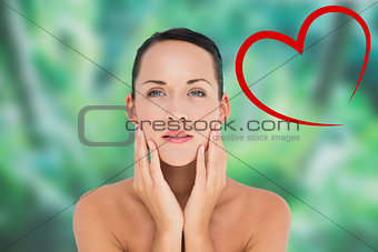 Composite image of beautiful nude brunette posing with hands on face