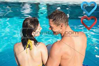 Composite image of smiling young couple in swimming pool