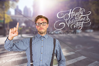 Composite image of geeky hipster covered in kisses