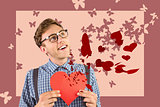 Composite image of geeky hipster holding a heart card