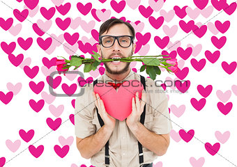 Composite image of geeky hipster offering valentines gifts