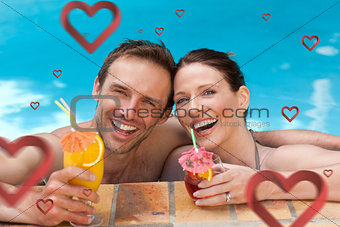 Composite image of beautiful couple drinking cocktails in the swimming pool