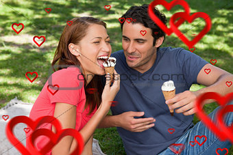 Composite image of woman eating ice cream while sitting with her friend