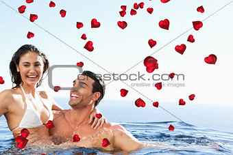 Composite image of couple enjoying time together in the pool