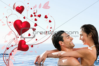 Composite image of couple embracing in the pool