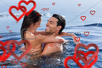 Composite image of delighted couple cuddling each other