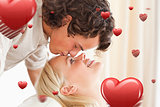 Composite image of close up of a man kissing his fiance on the forehead