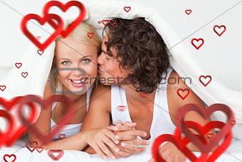 Composite image of man kissing his girlfriend on the cheek