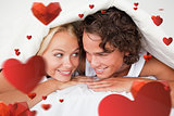 Composite image of couple under a duvet with a knowing smile