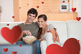 Composite image of couple with popcorn on the sofa watching a movie