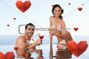 Composite image of cheerful couple having cocktails in the pool
