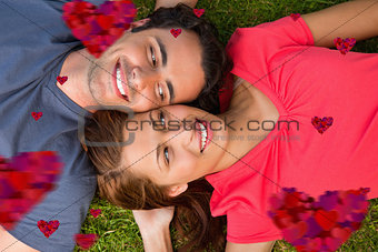 Composite image of two friends looking at each other while lying head to shoulder