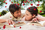 Composite image of two friends looking at each other while reading books on a blanket