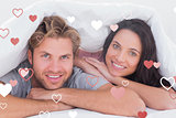 Composite image of beautiful couple smiling under the cover