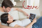 Composite image of prospective parents looking at ultrasound scan on tablet pc