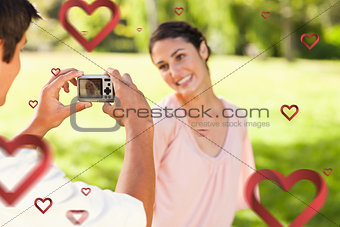Composite image of man takes a photo of his smilng friend