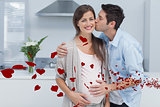 Composite image of man kissing his pregnant wife