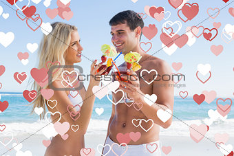 Composite image of happy young couple holding cocktails