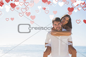 Composite image of smiling man giving girlfriend a piggy back looking at camera