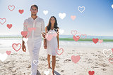 Composite image of beautiful couple holding hands and walking towards camera