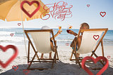 Composite image of happy couple drinking cocktails while relaxing on their deck chairs
