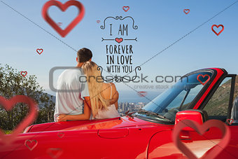 Composite image of rear view of couple hugging and admiring panorama