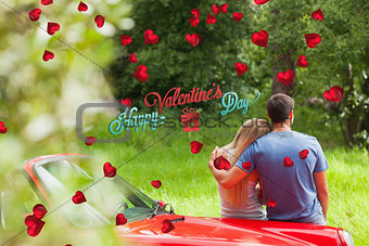 Composite image of loving couple admiring nature while leaning on their cabriolet