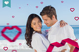 Composite image of young couple embracing and posing on the beach