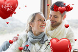 Composite image of cheerful young couple in winter clothing