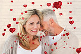 Composite image of happy couple laughing together woman looking at camera