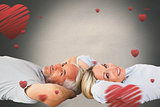 Composite image of smiling couple lying and looking at camera