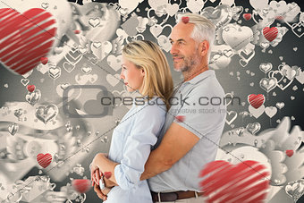 Composite image of happy couple smiling and embracing